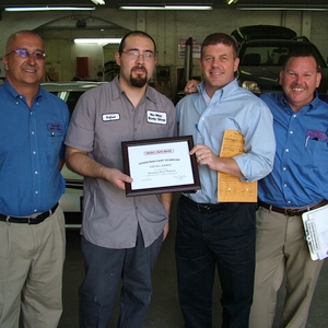 From left to right: Rodney Edward, shop manager; Rafael Ramos, journeyman paint technician; Rich Powers, regional manager; and Vince McDonnell, director of operations.