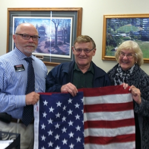 Darrell Amberson, ASA chairman, left, presents Bill Sauer, Identifix co-founder, with an American flag that was flown over the U.S. Capitol and a letter of recognition for his contributions to the automotive service industry. Sauer was joined by his wife, Duffy.
