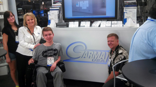 Corey Milton (center) hangs out at Garmats Booth 11155 with (left to right) Stepsister Fianna, nephew Debbie Teter and dad Brandon.