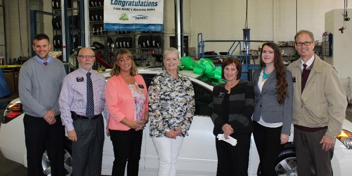 LaMettry’s Collision team with Recycled Rides recipient Cheryl Zaun (center). From left to right: Randy LaMettry (vice president), Darrell Amberson (president of operations), Laurie Kaiser (CMO), Recycled Rides recipient Cheryl Zaun, Ann Bruce (sales), Stefany Lorang (creative director), Mike Elliott (sales).