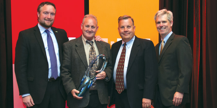 Sandy Reshes, co-owner of Colortone Automotive Paints, (second from left) accepts his award from (left to right) Paul Whittleston, BASF vice president; Rich Hougland, BASF regional manager and John Moreau, BASF key accounts manager.