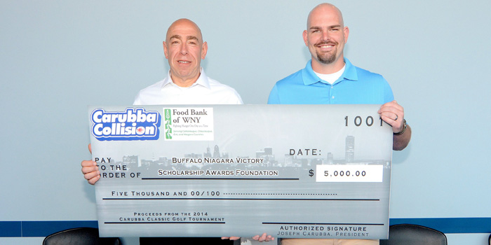 From left, Carubba Collision Corp. President Joe Carubba presents a $5,000 check to Buffalo Niagara Victory Award Scholarship Foundation President Frank Remillard.