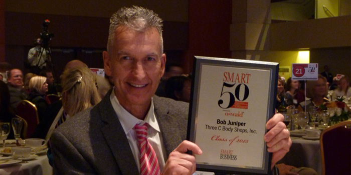 Bob Juniper, Three-C Body Shops president, with Smart 50 Award.