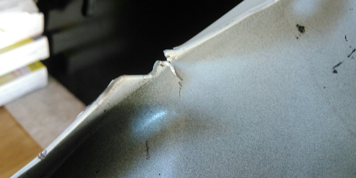A crack that formed during an attempted repair – a common problem as aluminum has no memory. Proper heat would have helped to prevent the cracking.